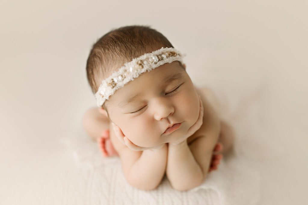 newborn baby girl photographed in warm studio by Puyallup newborn photographer