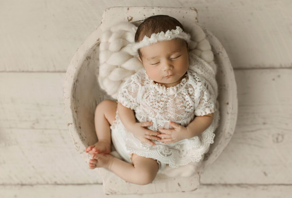 newborn girl peacefully sleeping during studio session in Puyallup in prop