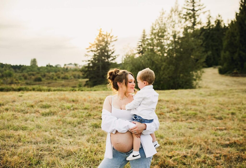 Family maternity session in Kent WA field during golden hour light