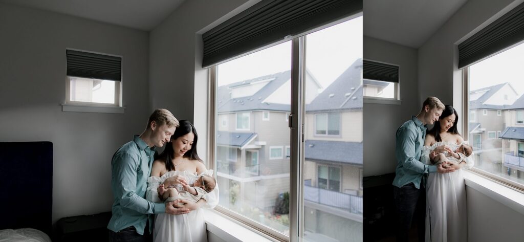 Mother holding newborn during in-home newborn photography session in Seattle