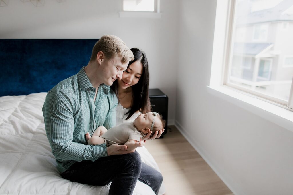 parents holding baby girl in seattle newborn family session 