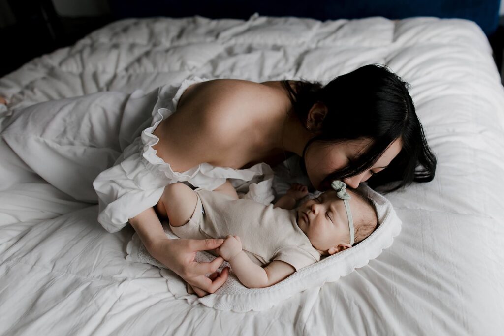 mom holding baby girl in seattle newborn family session