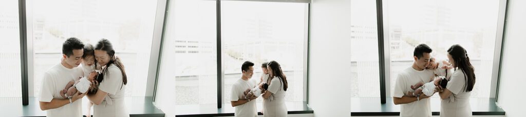 Family cuddling their newborn during a hospital Fresh 48 photography session in Seattle