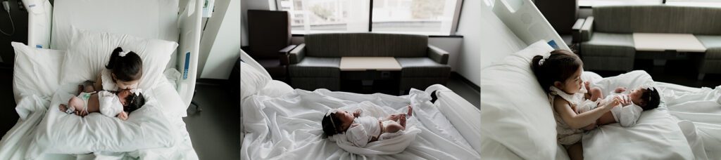 Toddler gently kissing newborn during a hospital Fresh 48 session in Seattle