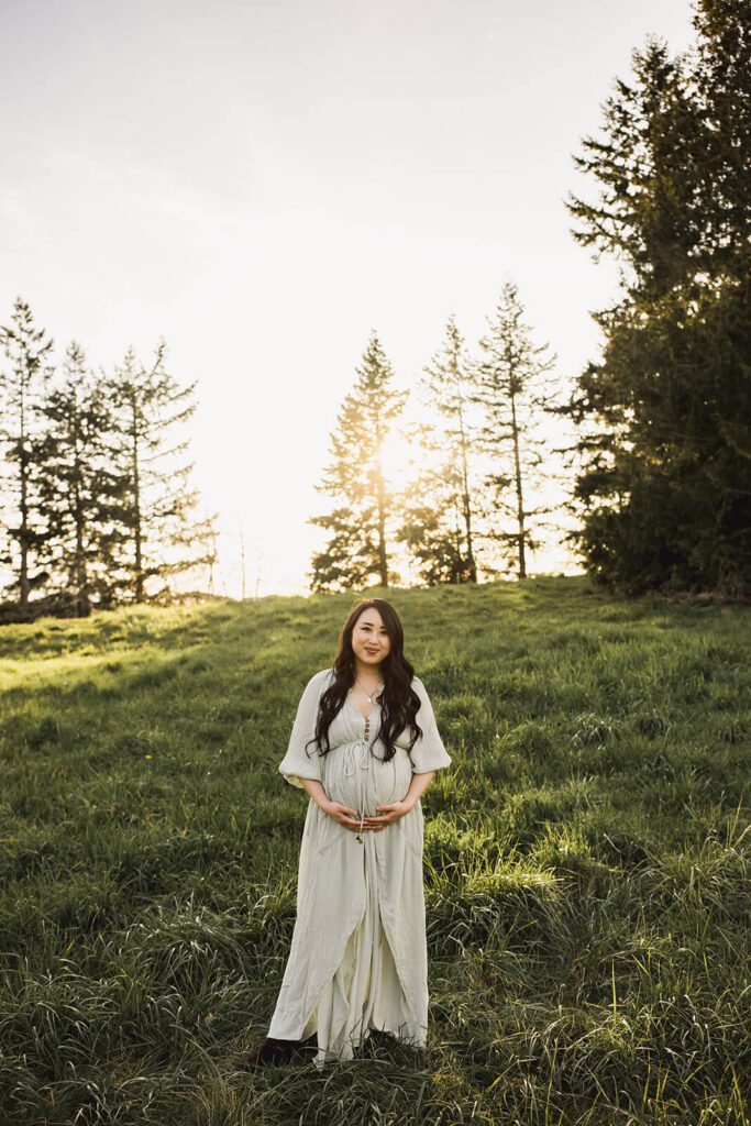Expecting mother wearing a flowing maternity gown during a Seattle maternity photography session